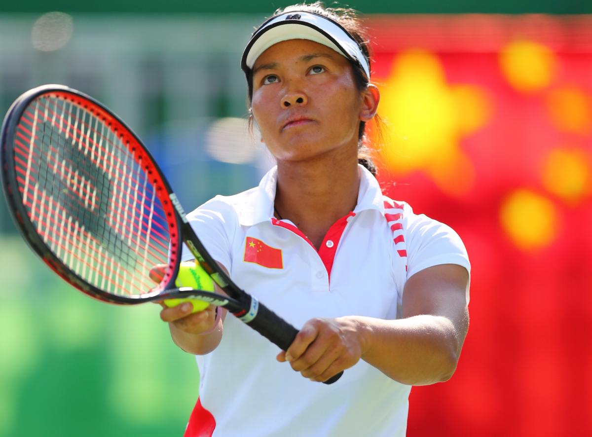 China's Zhenzhen Zhu lines up a serve.