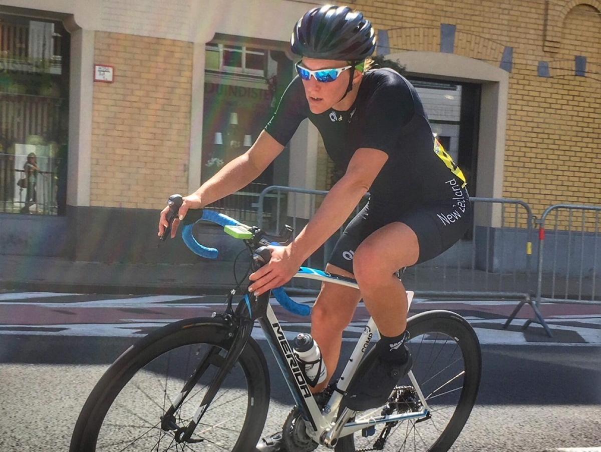 a female Para cyclist comes round a road bend