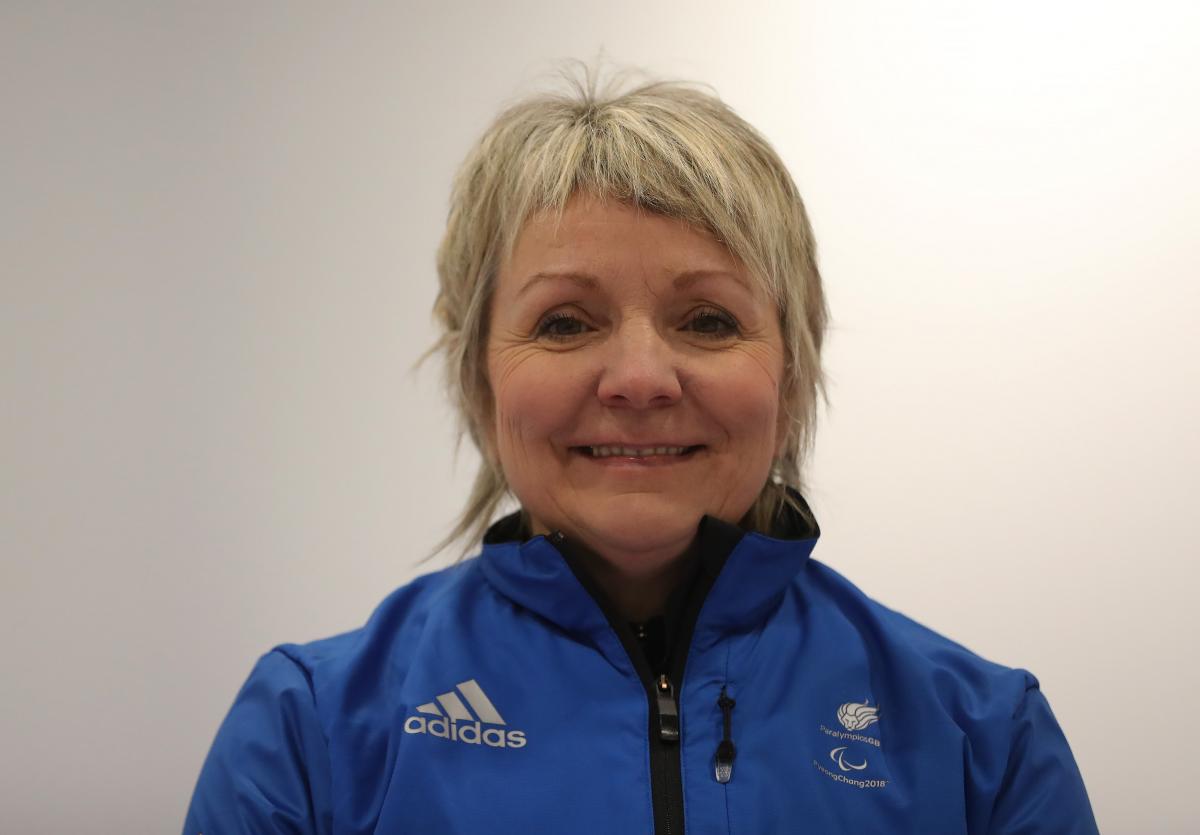 a female wheelchair curler smiles for the camera