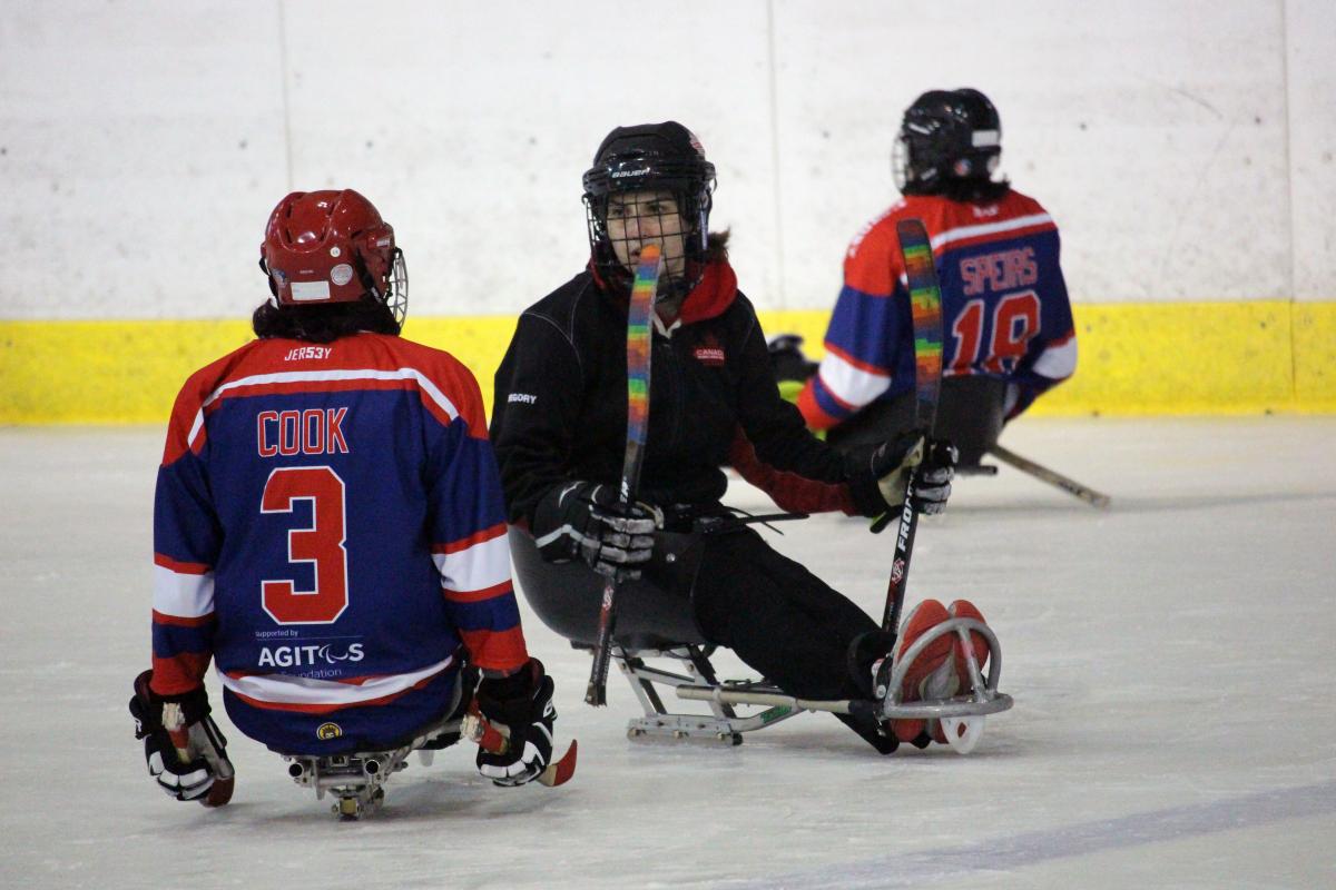 Para ice hockey athlete talks to coach during training camp in Czech Republic 