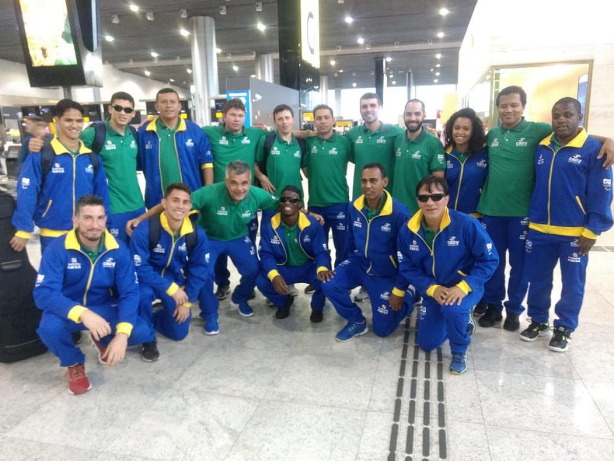 A group of blind footballers smiling in an airport
