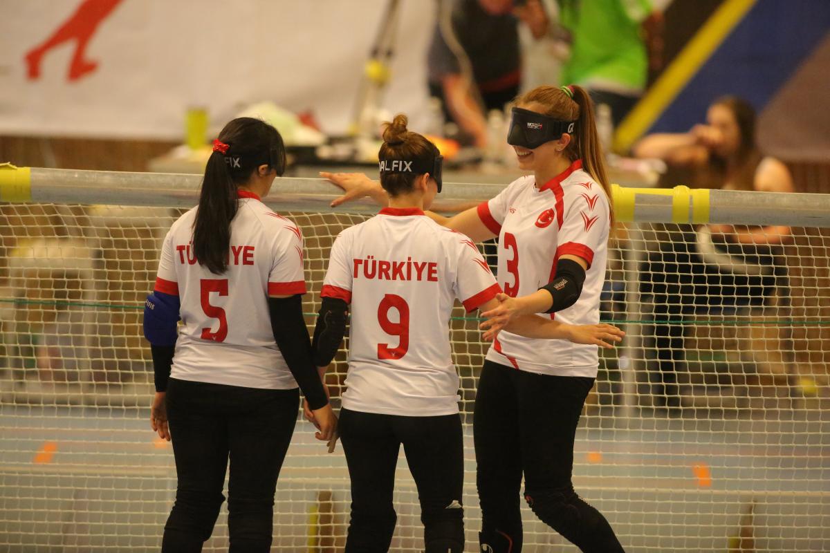 Turkey goalball women - Malmo 2018 three female goalball players hug in celebration in front of the goal