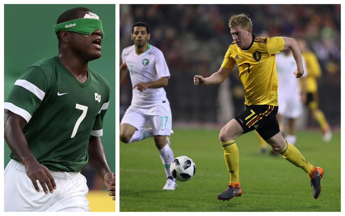 a male blind football player and a male able-bodied footballer dribbling with the ball