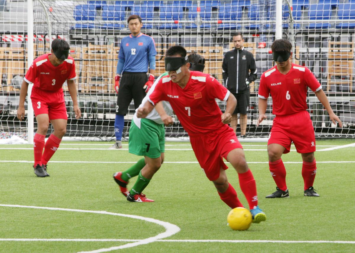 China beat Mexico - Madrid 2018 A male blind footballer dribbles past another player