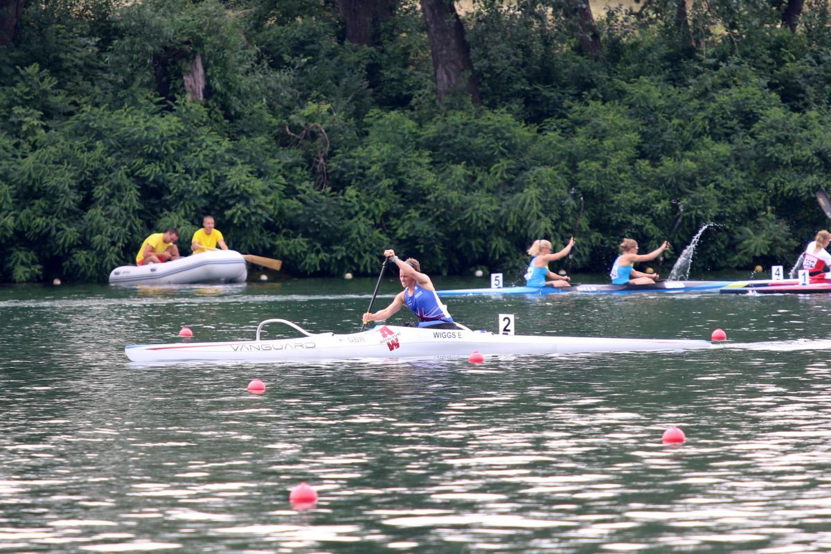 a female Para canoeist mid-stroke on the water