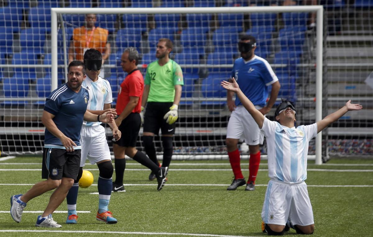 Argentina blind football - Madrid 2018 a male blind footballer celebrates on his knees after scoring a goal