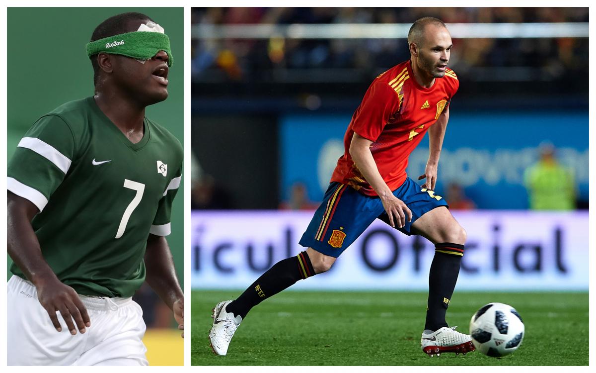 a male blind footballer and a male able-bodied footballer on the pitch