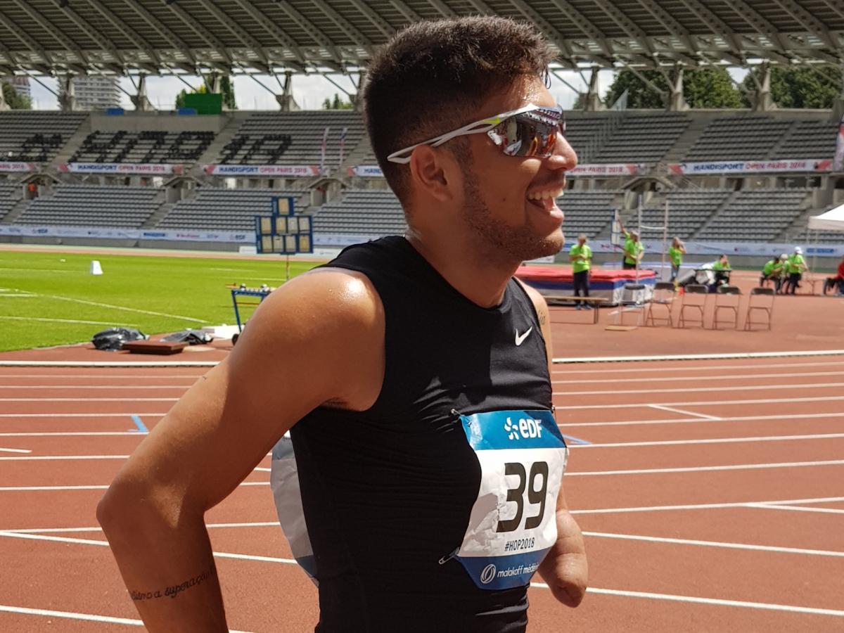 Petrucio Ferreira Dos Santos Man with sunglasses smiles to the crowd.