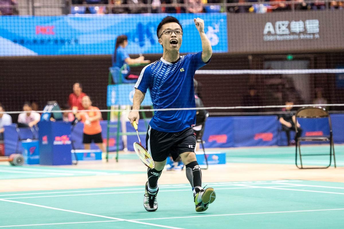 a male Para badminton player of short stature on the court