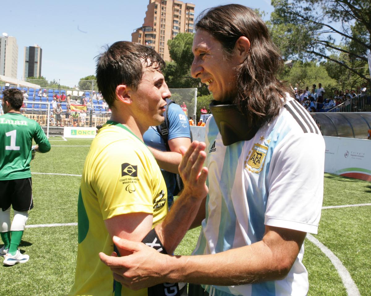 Ricardinho and Froilan Padilla two blind footballers hugging on the pitch