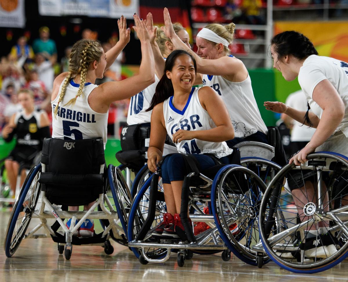 Women wheelchair basketball players celebrate