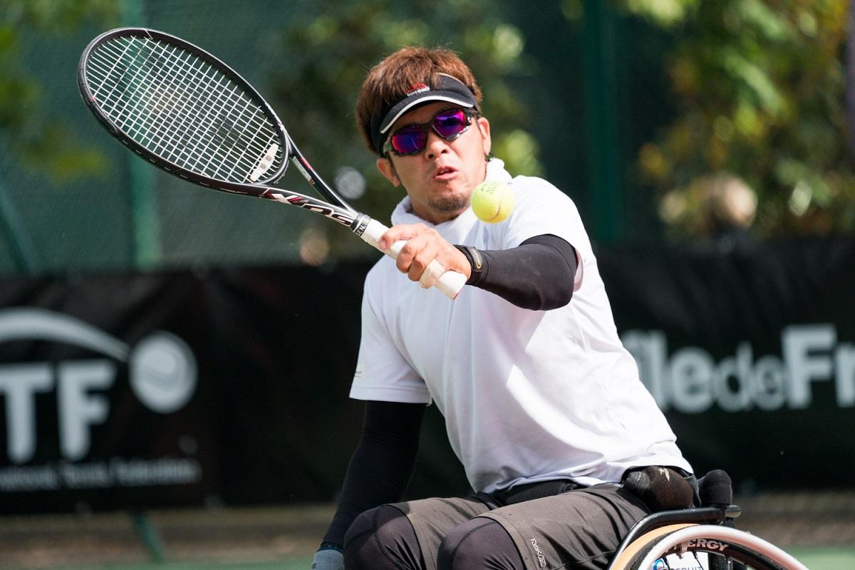 Koji Sugeno - 2018 Open de France a male wheelchair tennis player goes for a backhand shot