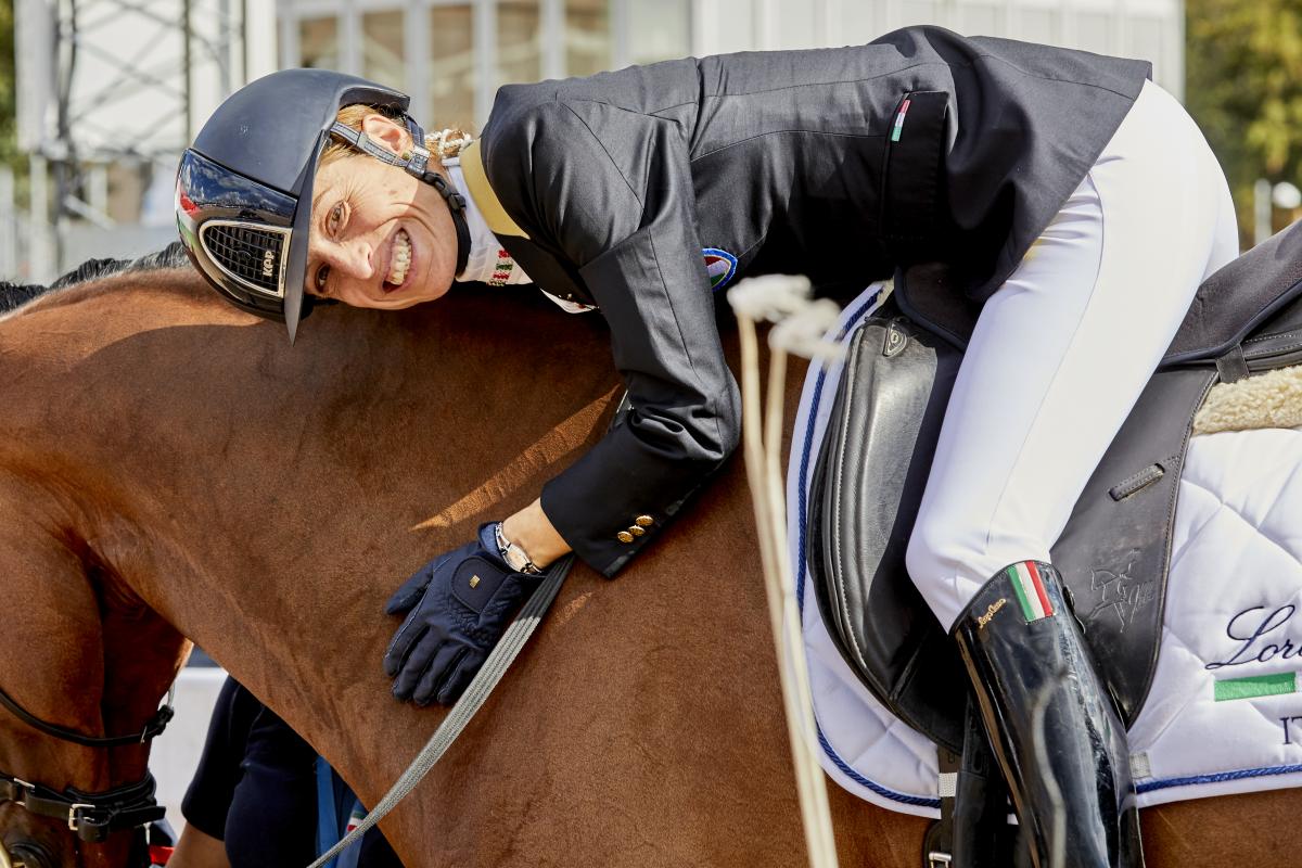 Sara Morganti a female Para equestrian rider hugging her horse