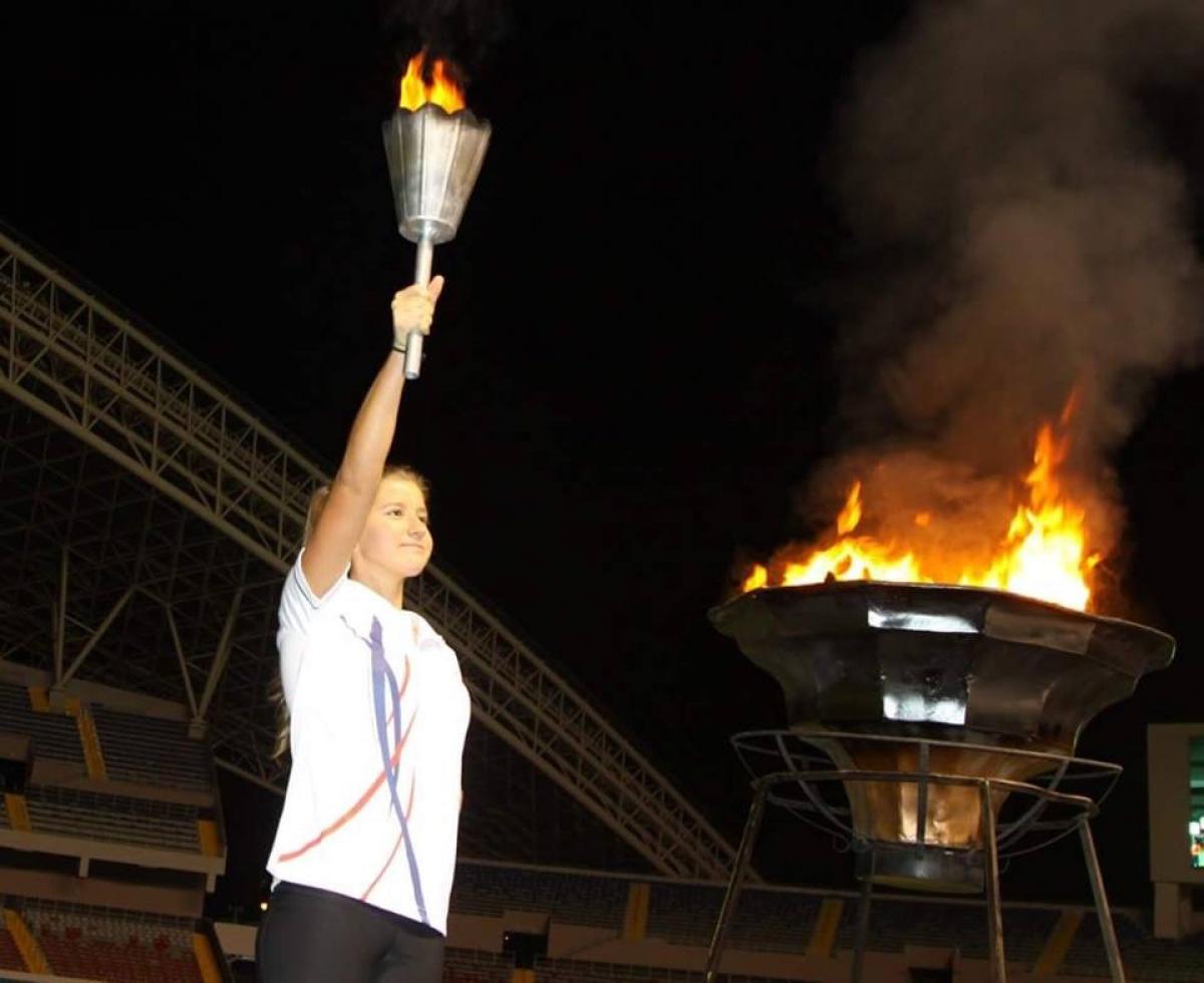 a female Para athlete lighting a cauldron