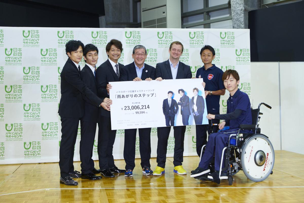 Nippon Foundation donation - I'm Possible and Agitos Foundation Six men standing and one in a wheelchair holding a cheque
