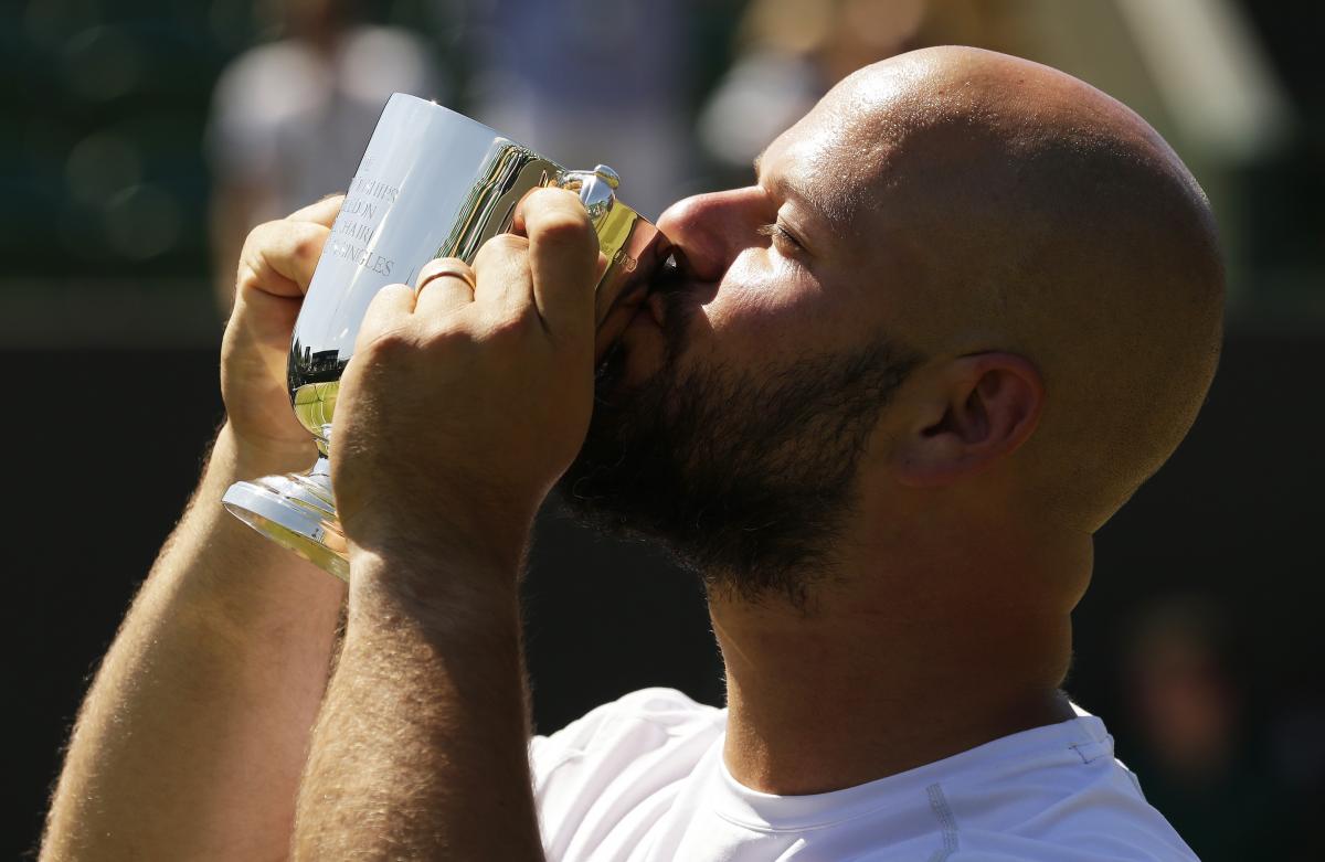 Stefan Olsson - Sweden - Wimbledon 2018 Men holding and kissing a small trophy