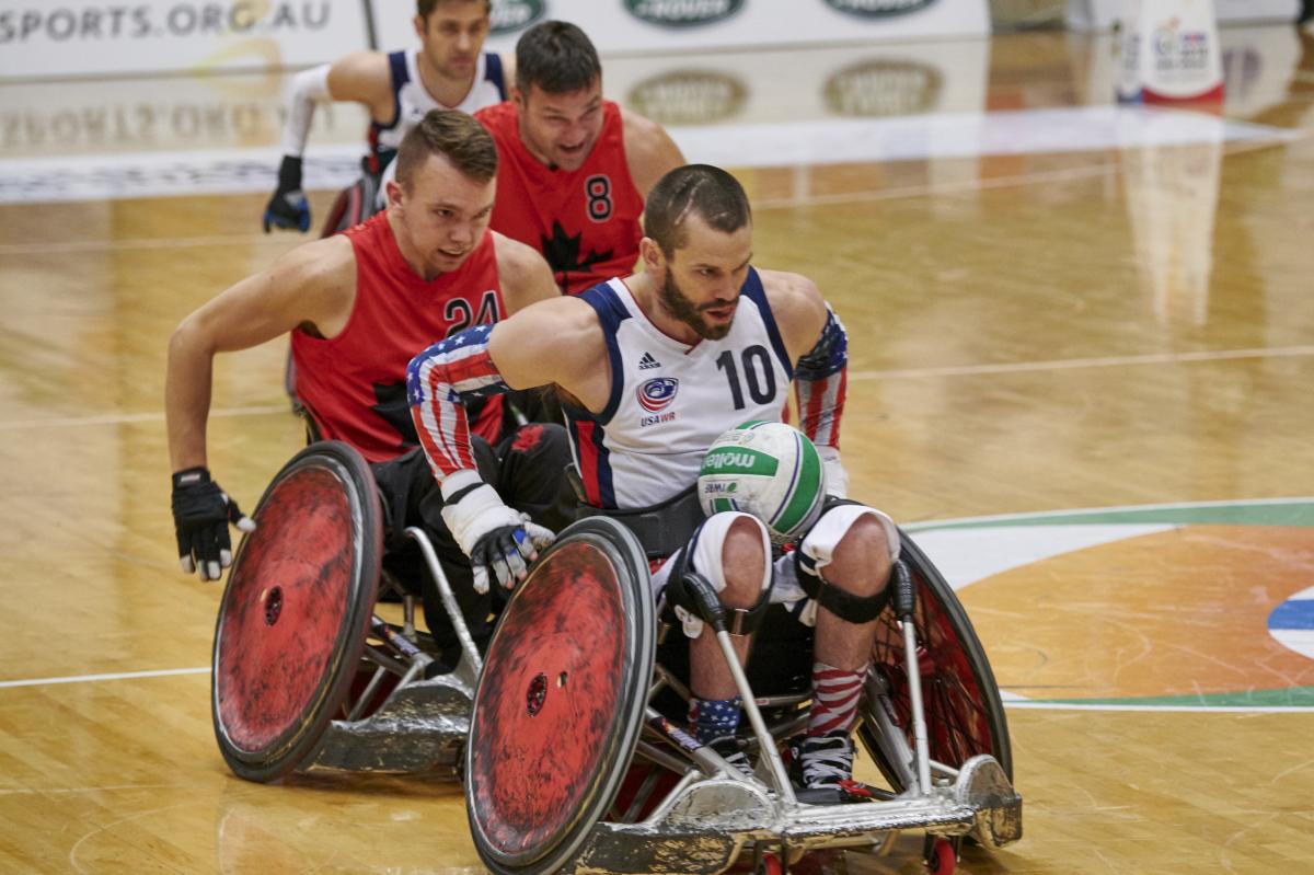 male wheelchair rugby player Josh Wheeler of USA sprints away with the ball