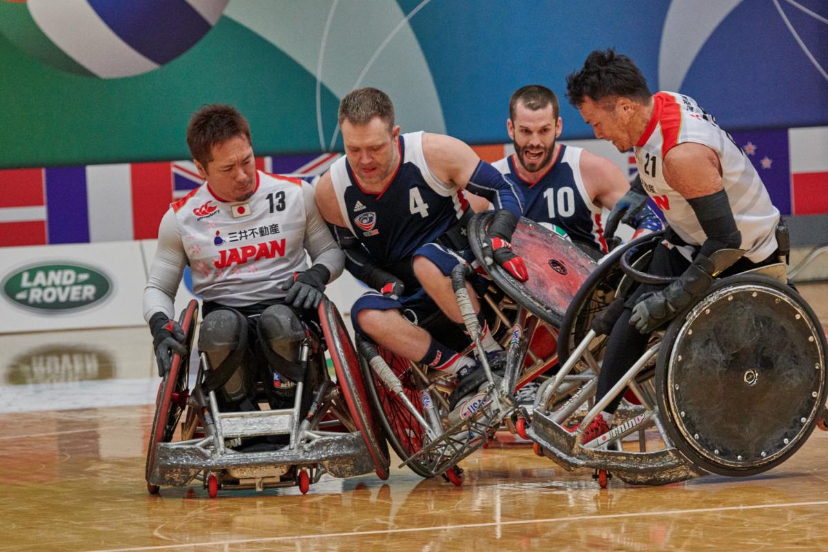 male wheelchair rugby players from USA and Japan clash on the court