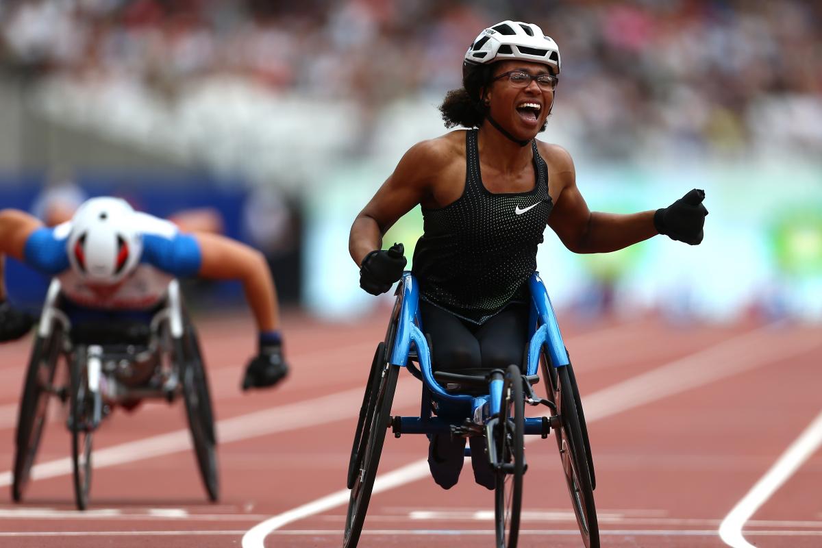 Kare Adenegan - Anniversary Games female wheelchair racer Kare Adenegan celebrates as she crosses the finish line
