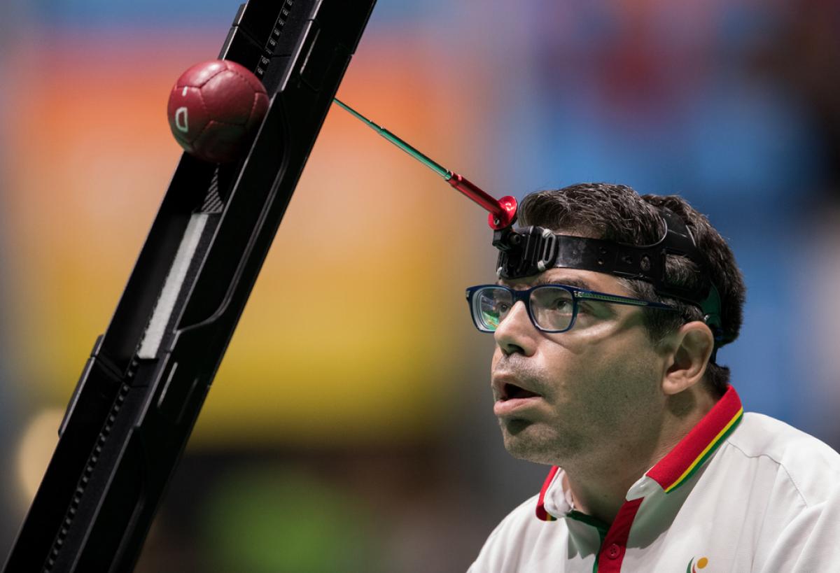 male boccia player Jose Macedo prepares to take a shot