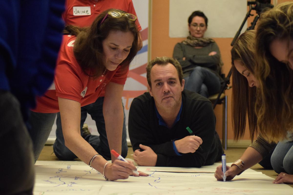 Representatives from Latin American NPCs work on a tarks during a marketing and communications workshop in Bogota