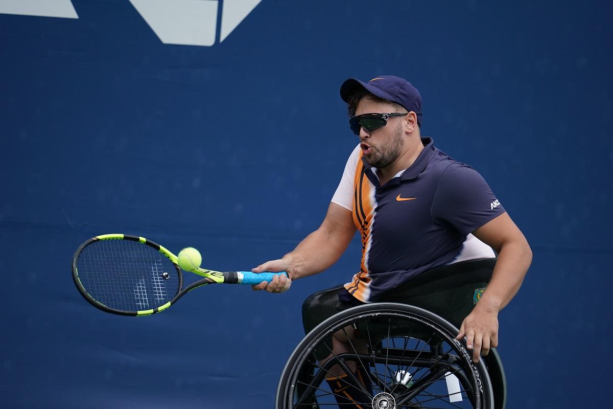 male wheelchair tennis player Dylan Alcott hits a forehand