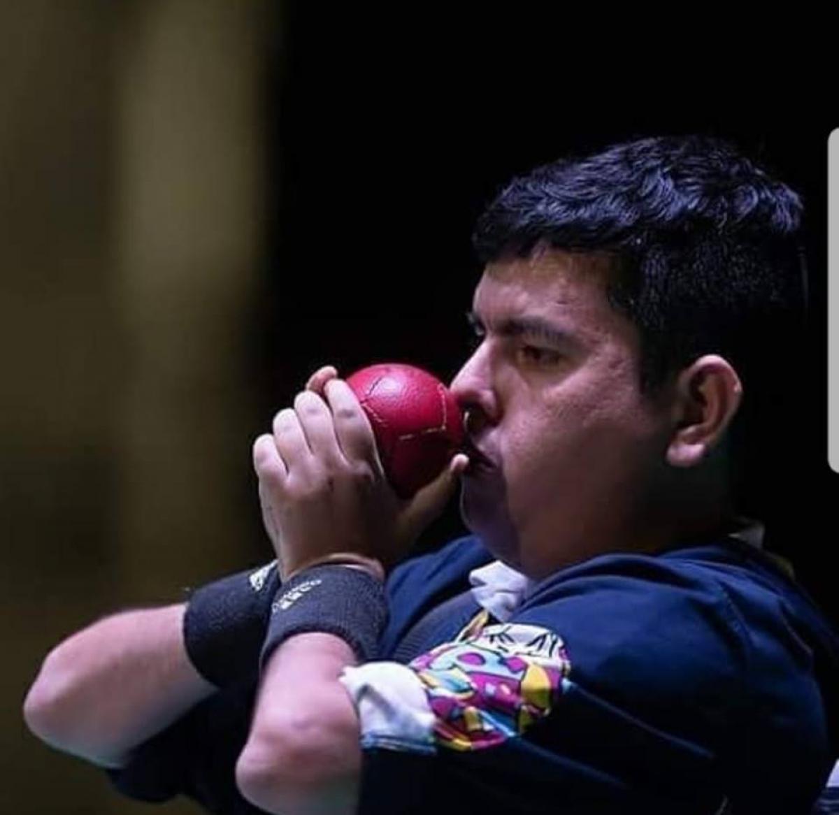 male boccia player Euclides Grisales prepares to throw the ball