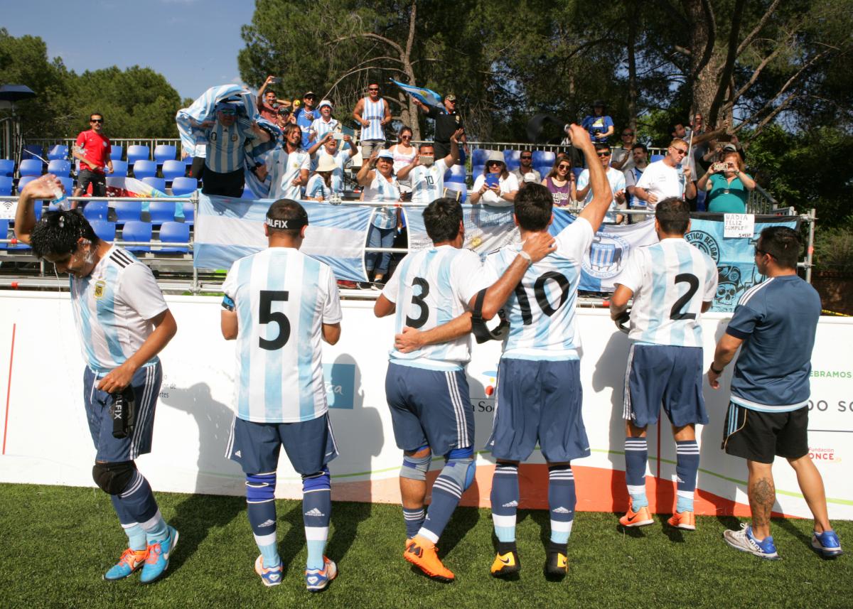 a group of Argentinian blind footballers dancing with their fans
