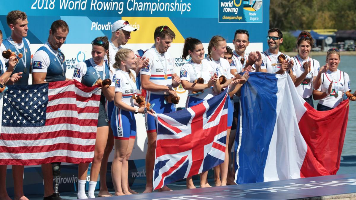 2018 World Rowing Championships - Plovdiv, Bulgaria - PR3 Mixed Coxed Four Group of female and male rowers on the podium with USA, Great Britain and France flags