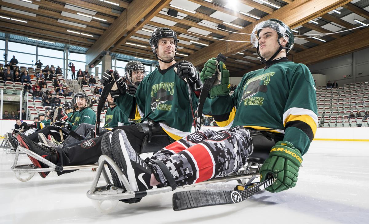 Para ice hockey - Ryan Straschnitzki - Canada - Humboldt Broncos survivor A group of men on sledges on ice