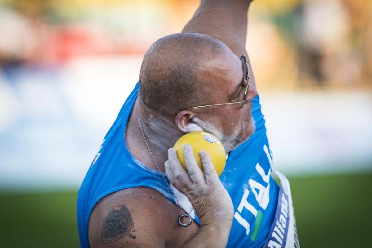 male Para athlete Giuseppe Campoccio prepares to throw a shot put