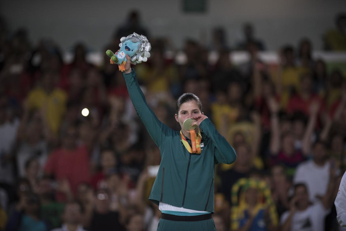 Woman kisses her medal