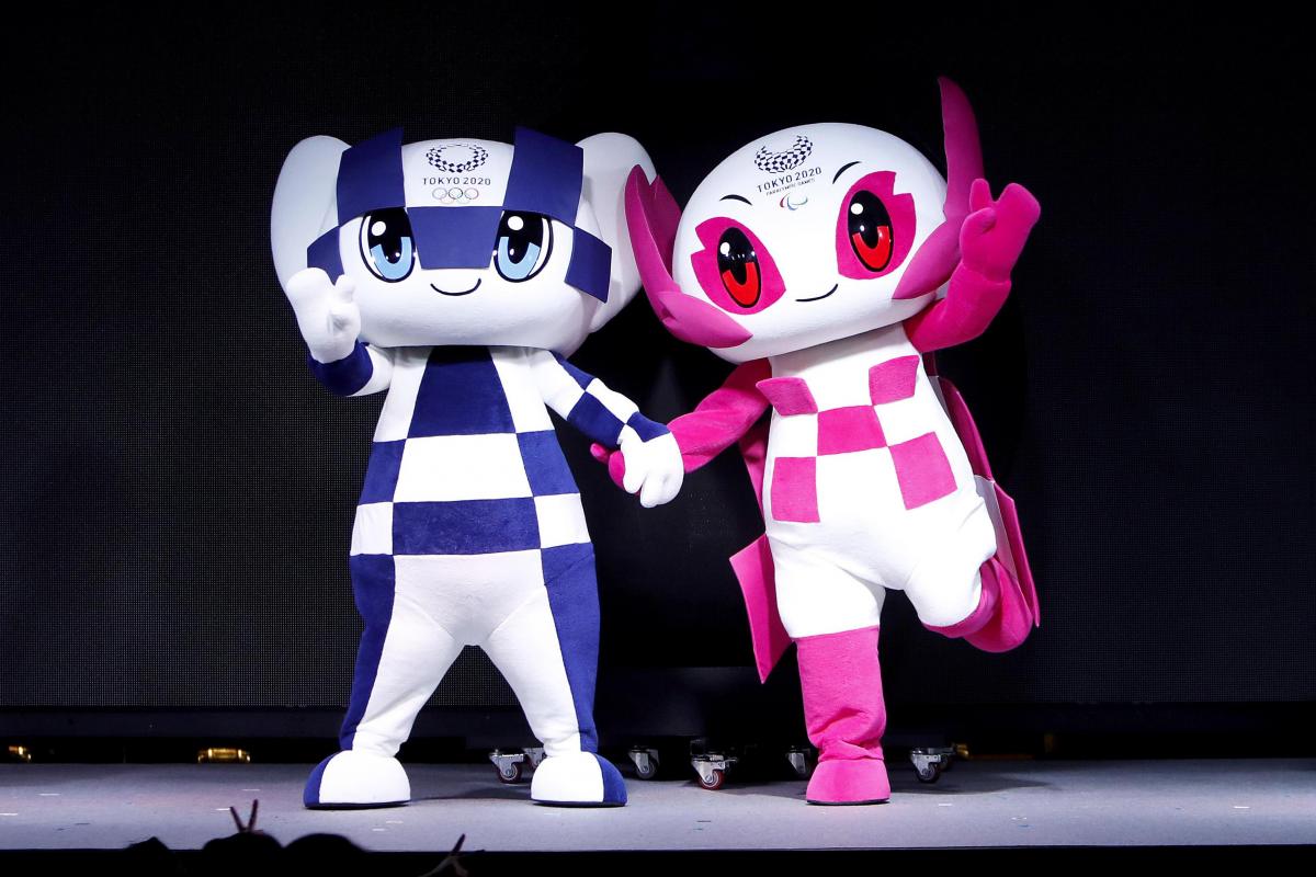 Tokyo 2020 - real life mascots the two mascots for the Tokyo 2020 Olympic and Paralympic Games holding hands on stage