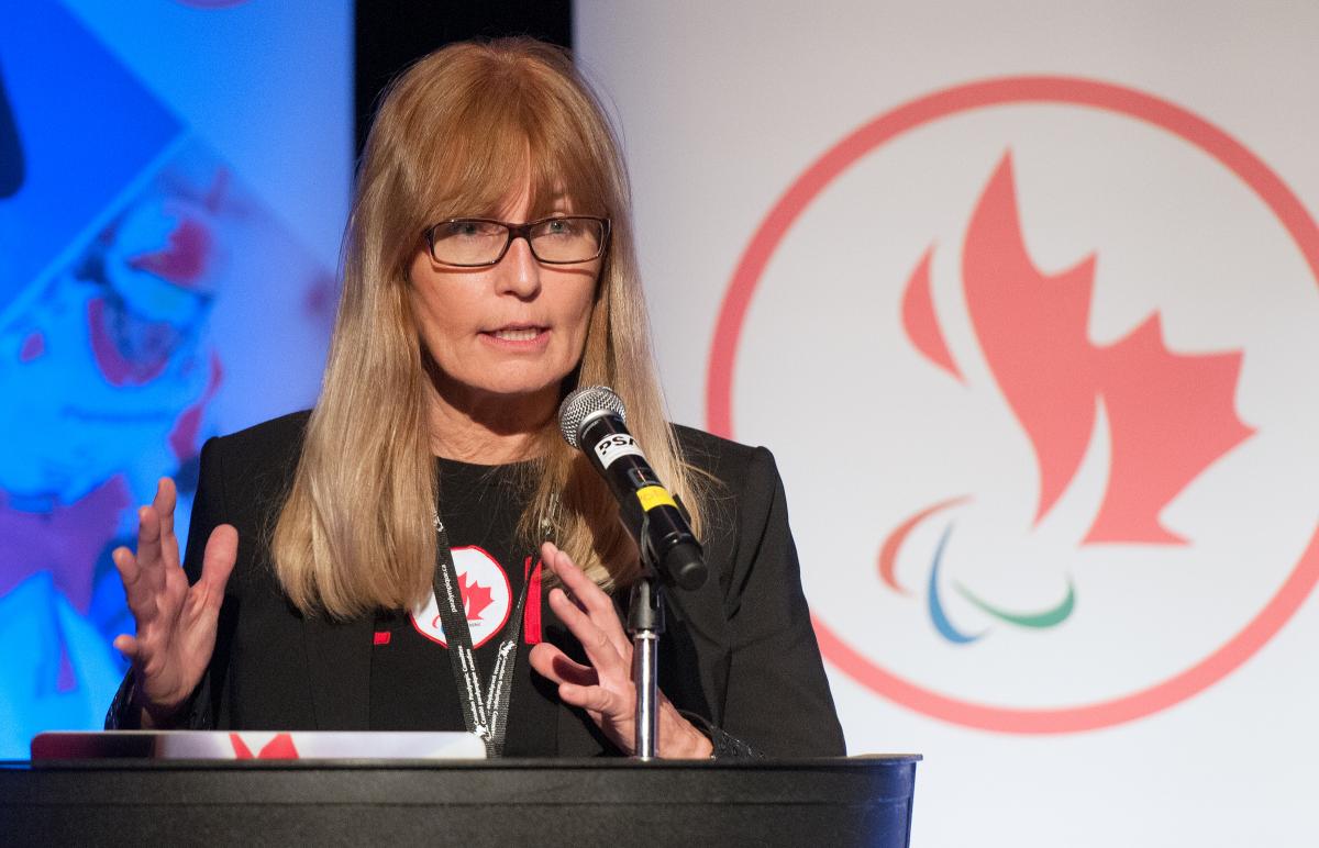 female chief executive Karen O’Neill speaking at a podium