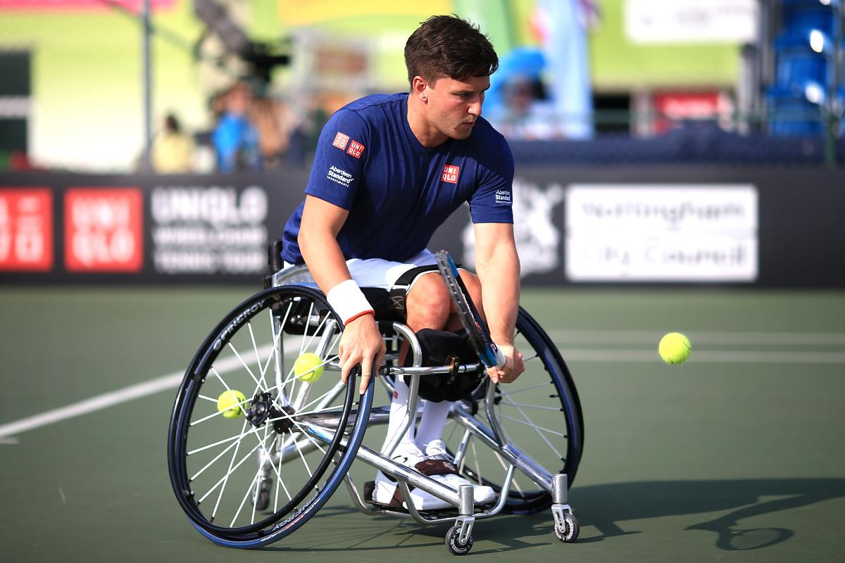 Gordon Reid male wheelchair tennis player Gordon Reid plays a low backhand on a hard court