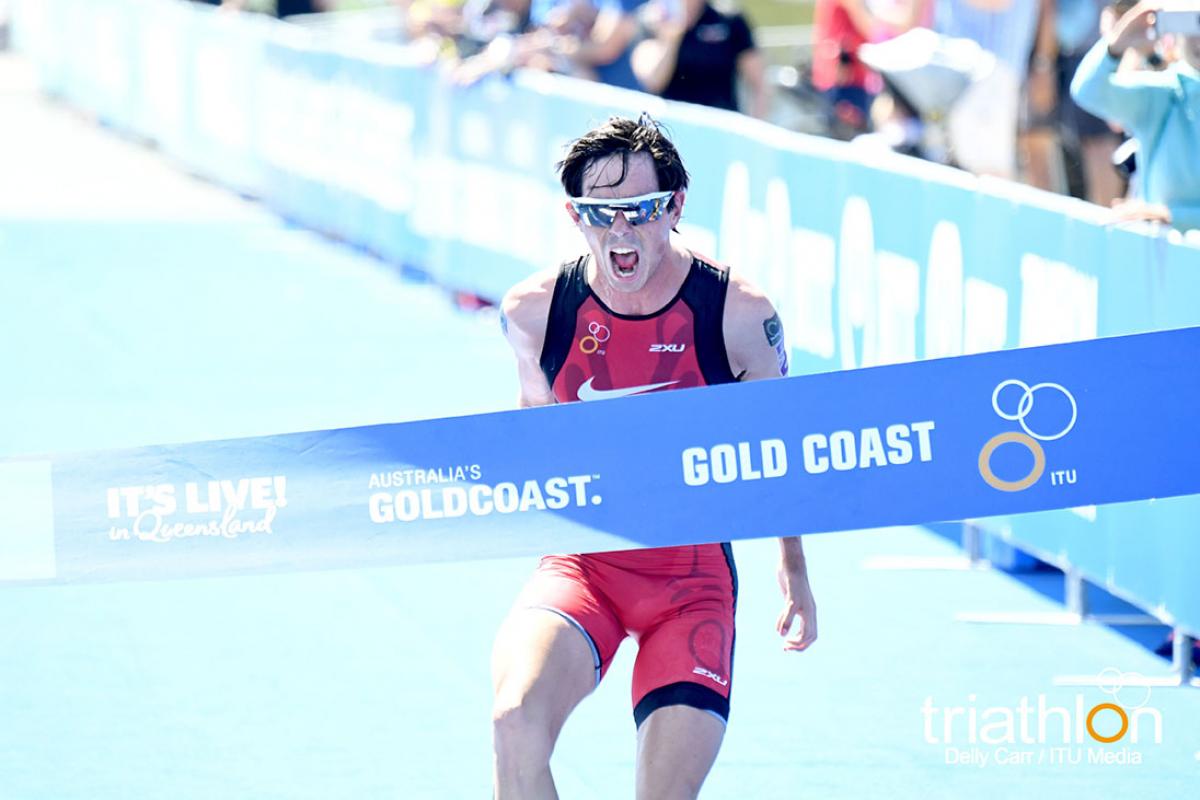 Para triathlete celebrates when crossing the line