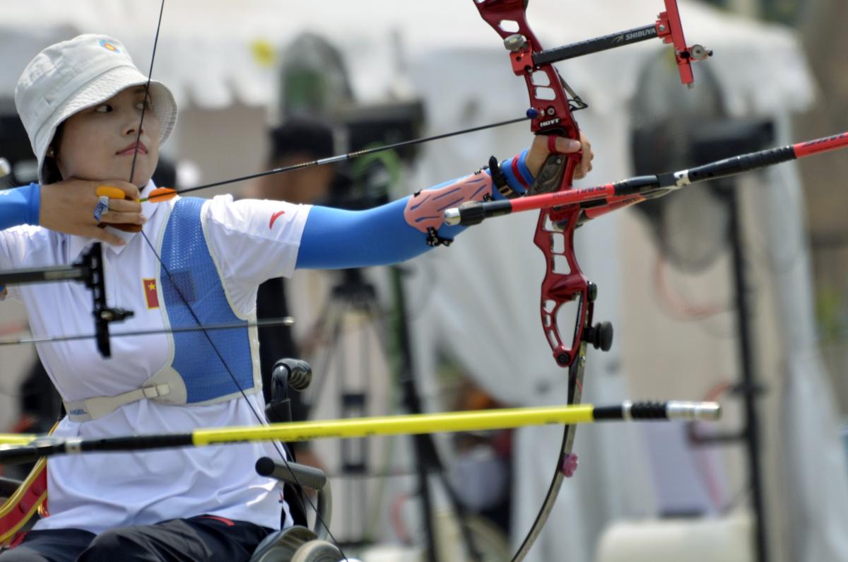 female Para archer Wu Chunyan draws back her bow to shoot an arrow