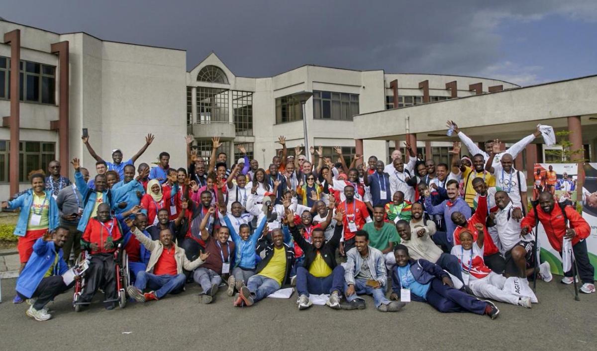 Group of people posing for a picture in front of a building