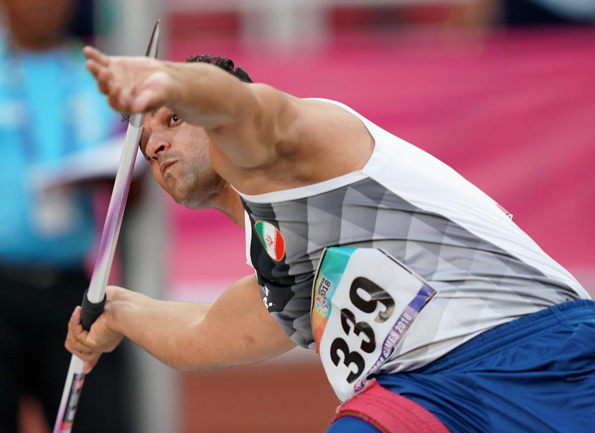 male Para athlete Amanolah Papi prepares to throw a javelin