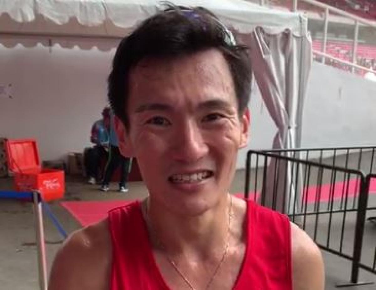 male Para athlete Zac Leow Zi Xiang smiles at the camera