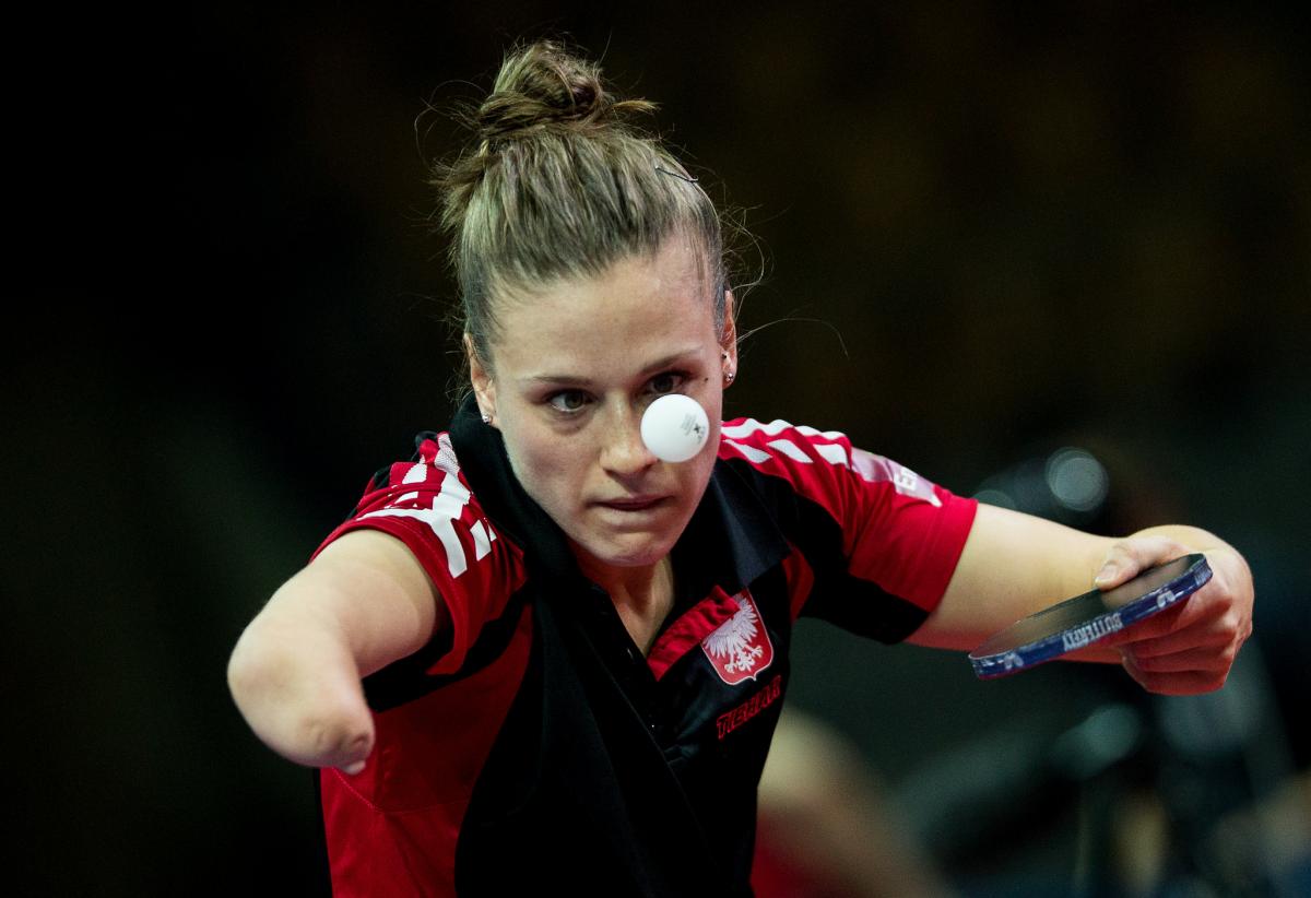 Natalia Partyka competing at the Para Table Tennis World Championships, holding the bat and watching the ball closely