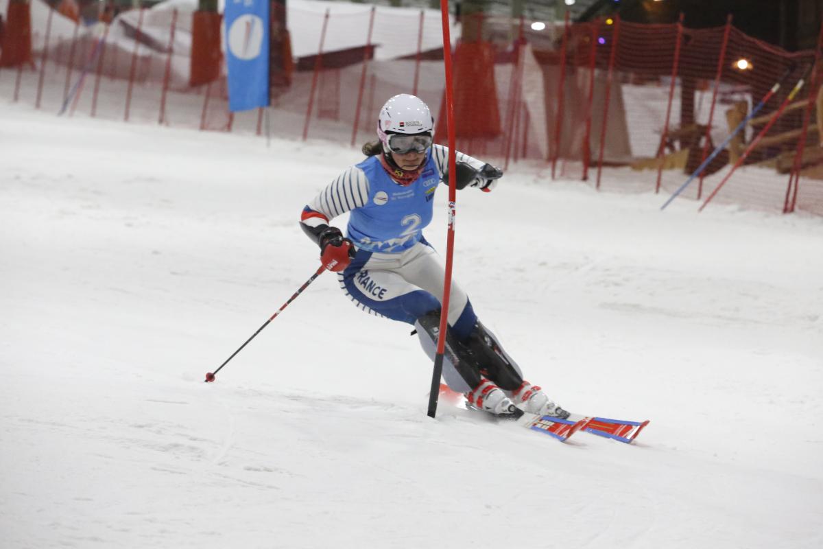 female Para alpine skier Marie Bochet goes round a gate