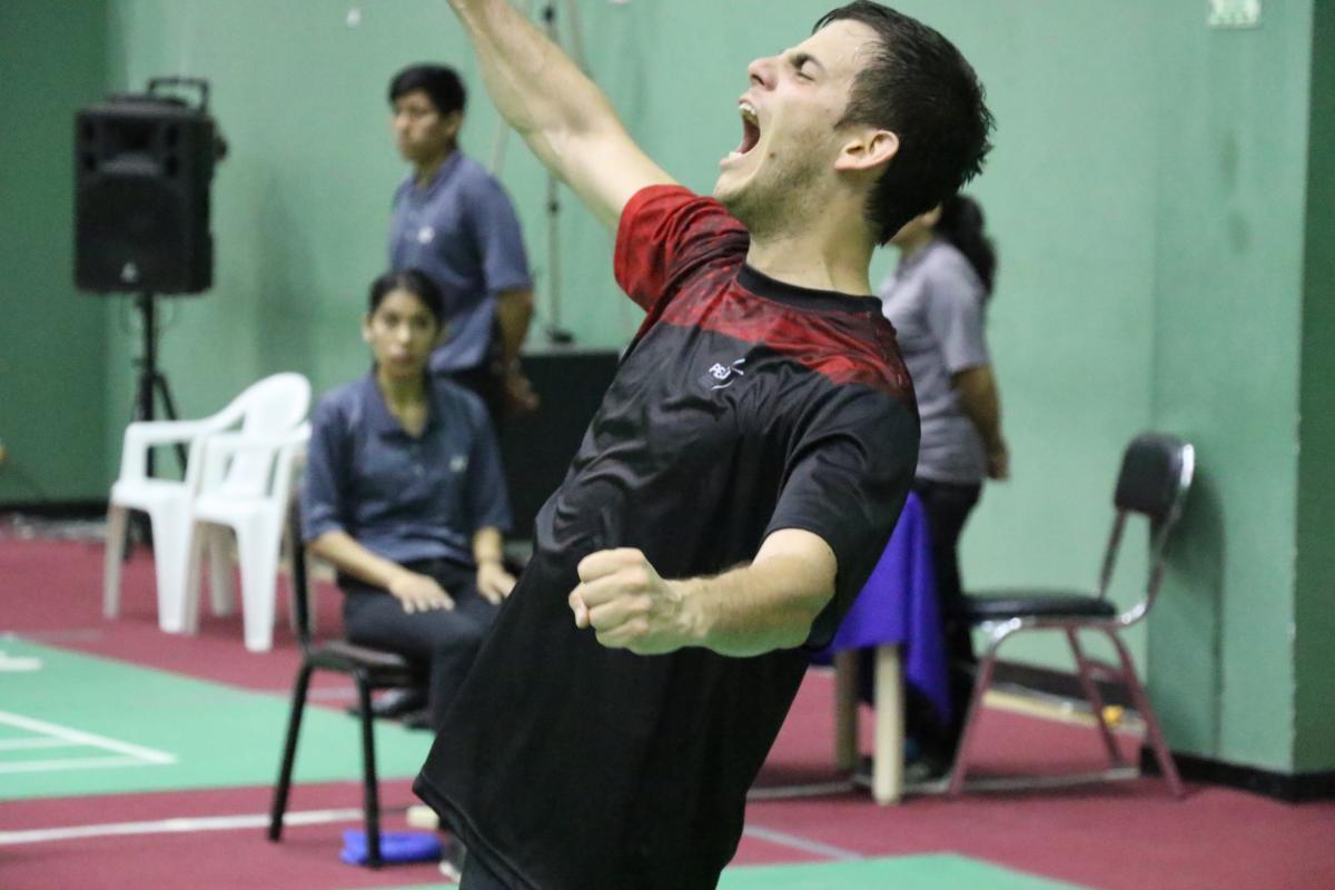 male badminton player Pedro Pablo de Vinatea screams and throws his arms up in celebration