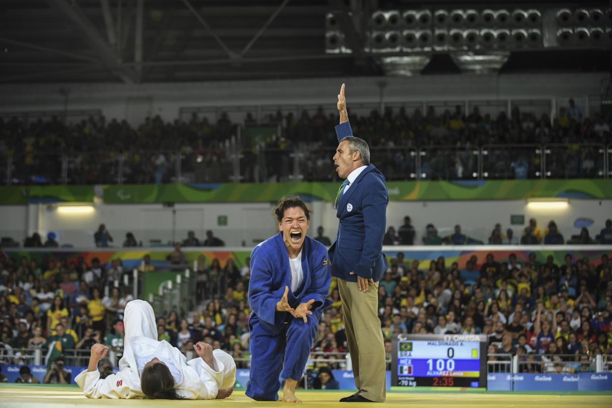 female judoka Lenia Ruvalcaba getting up off her knees and screaming in joy