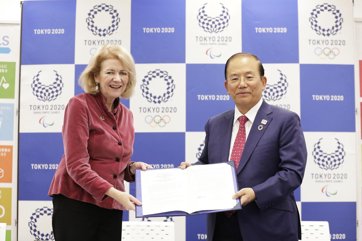 Tokyo 2020's Toshiro Muto and UN official holding a document together