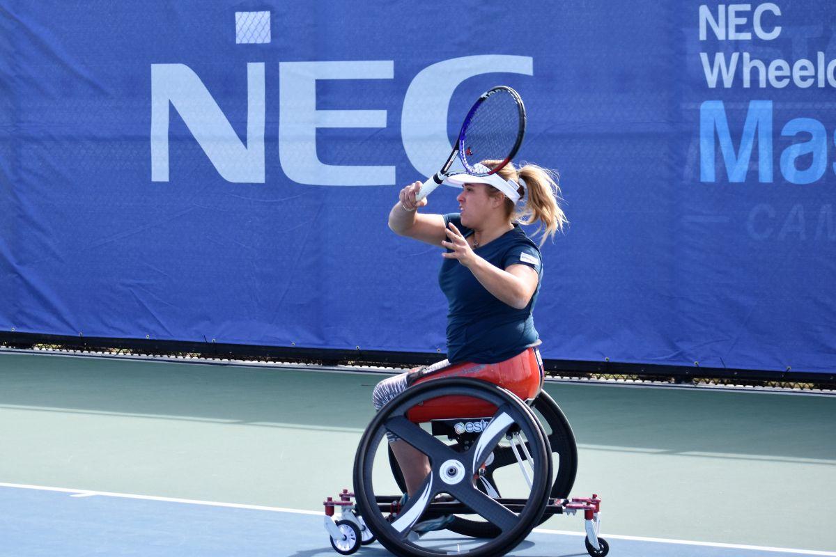 female wheelchair tennis player Giulia Capocci plays a forehand on a hard court