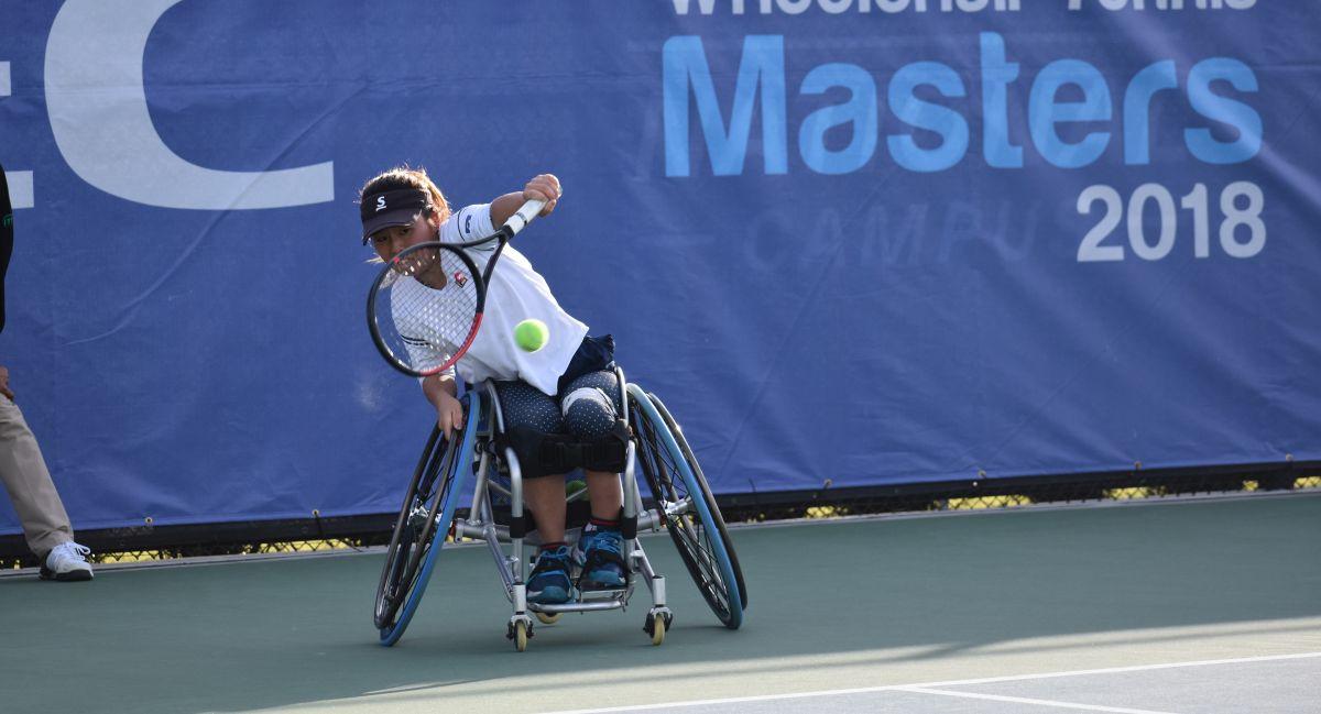 female wheelchair tennis player Yui Kamiji hits a backhand on a hard court