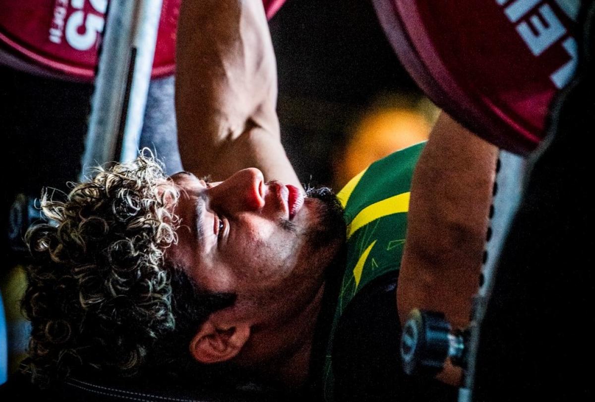 male powerlifter Joao Franca Junior prepares to lift the bar