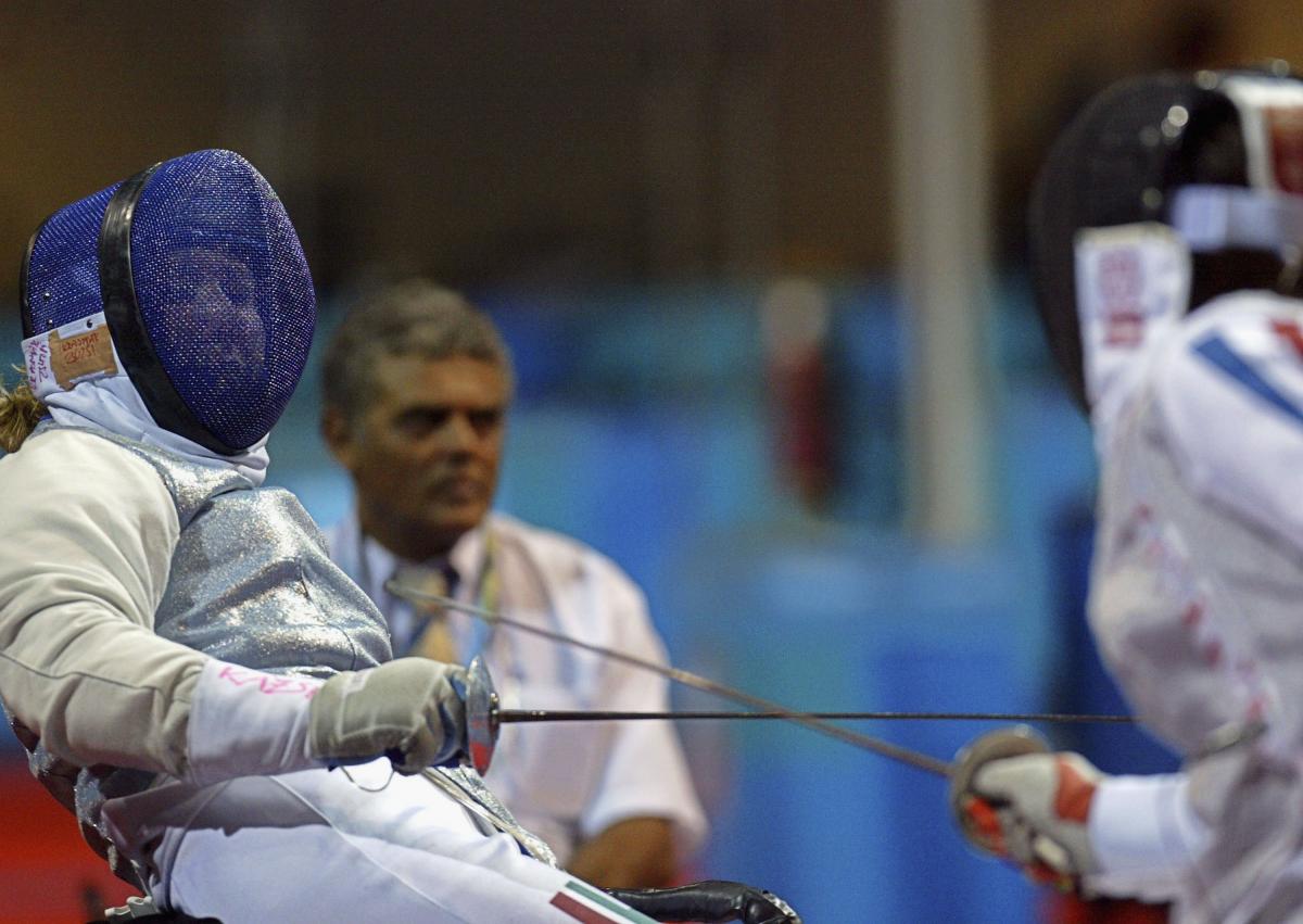 female wheelchair fencer Zsuzsanna Krajnyak dodges away from the foil