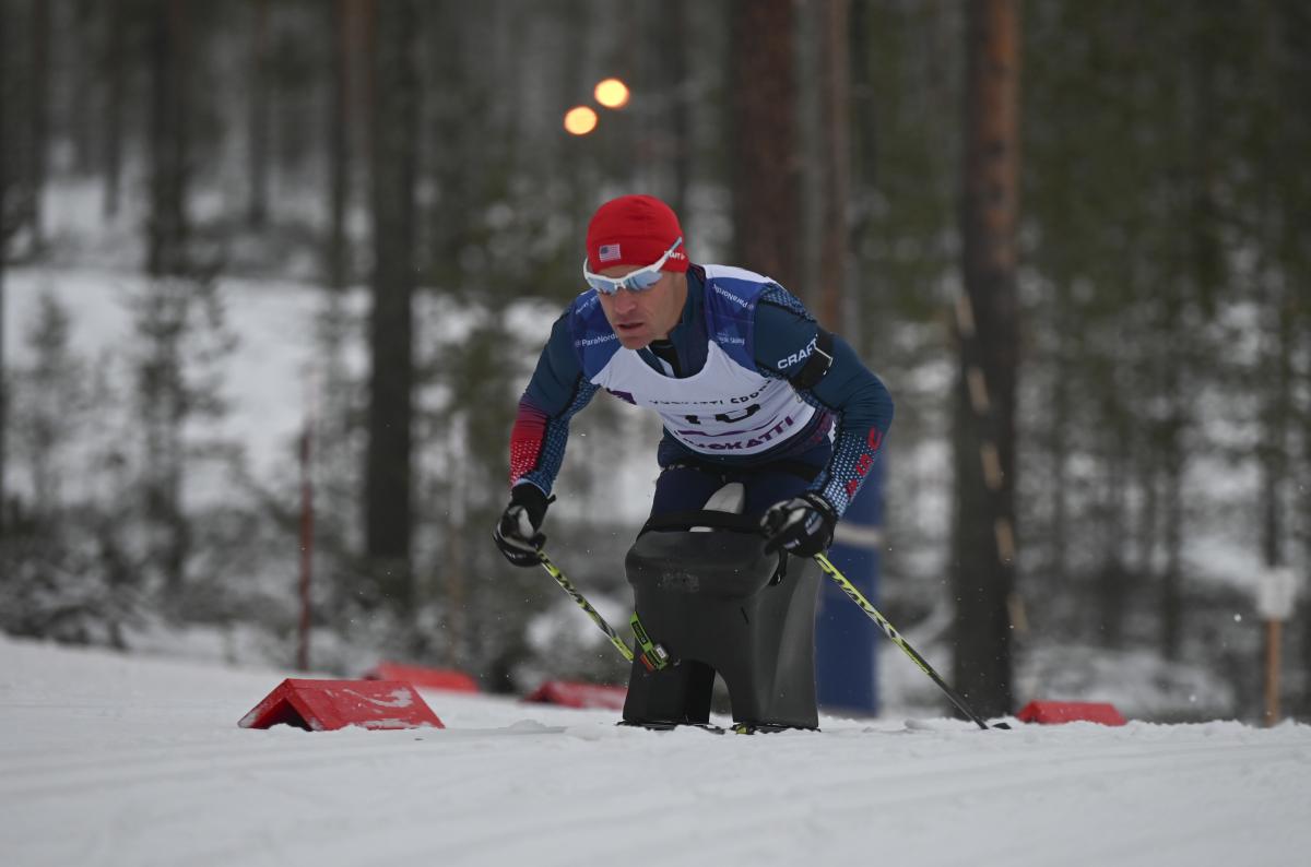 male Para Nordic sit skier Daniel Cnossen pushes through the snow